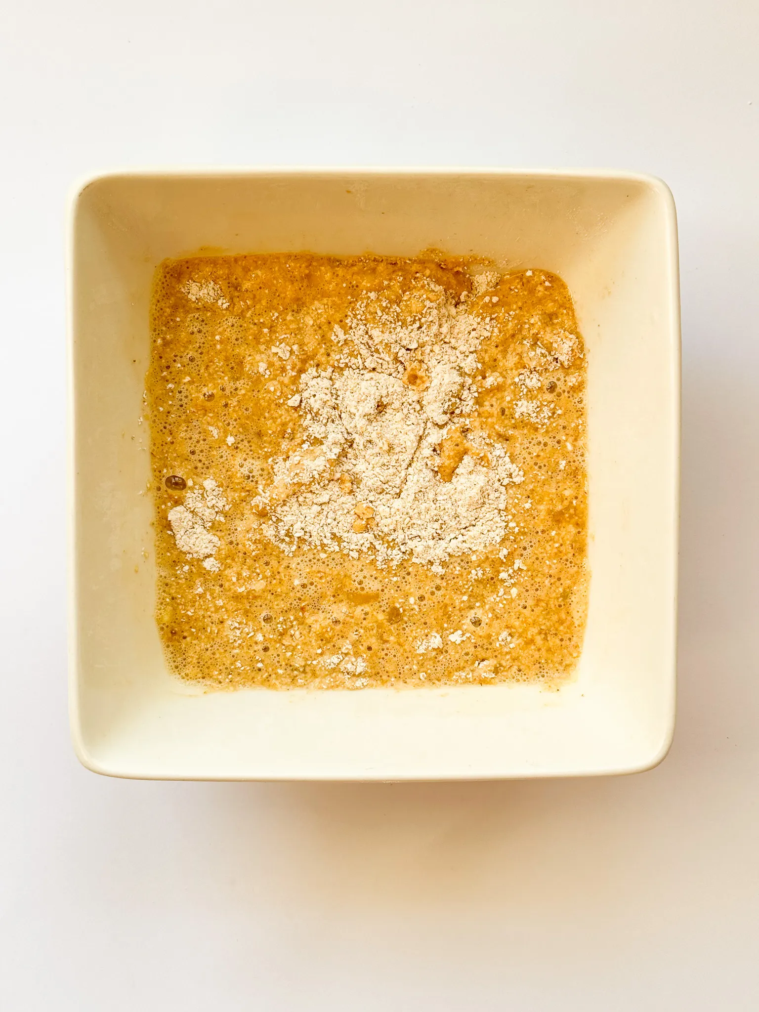 Incorporating wet mix into the dry mix.