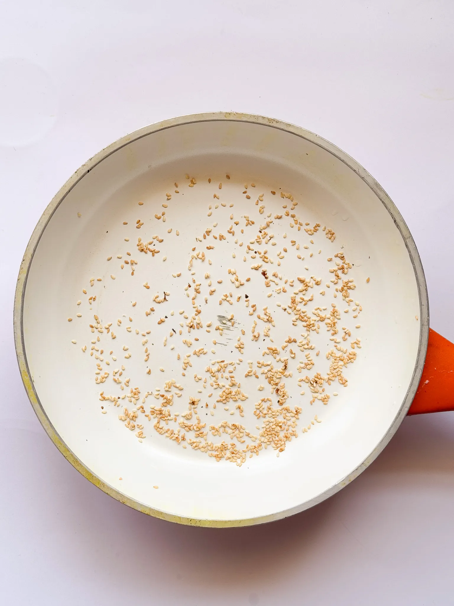 sesame seeds toasting in a skillet.