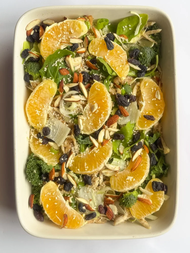 Quick and Healthy Asian Chicken Raisin Salad Plated In A Rectangular Tray.