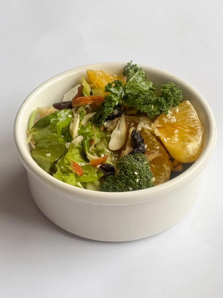 Quick and Healthy Asian Chicken Raisin Salad In A White Bowl.