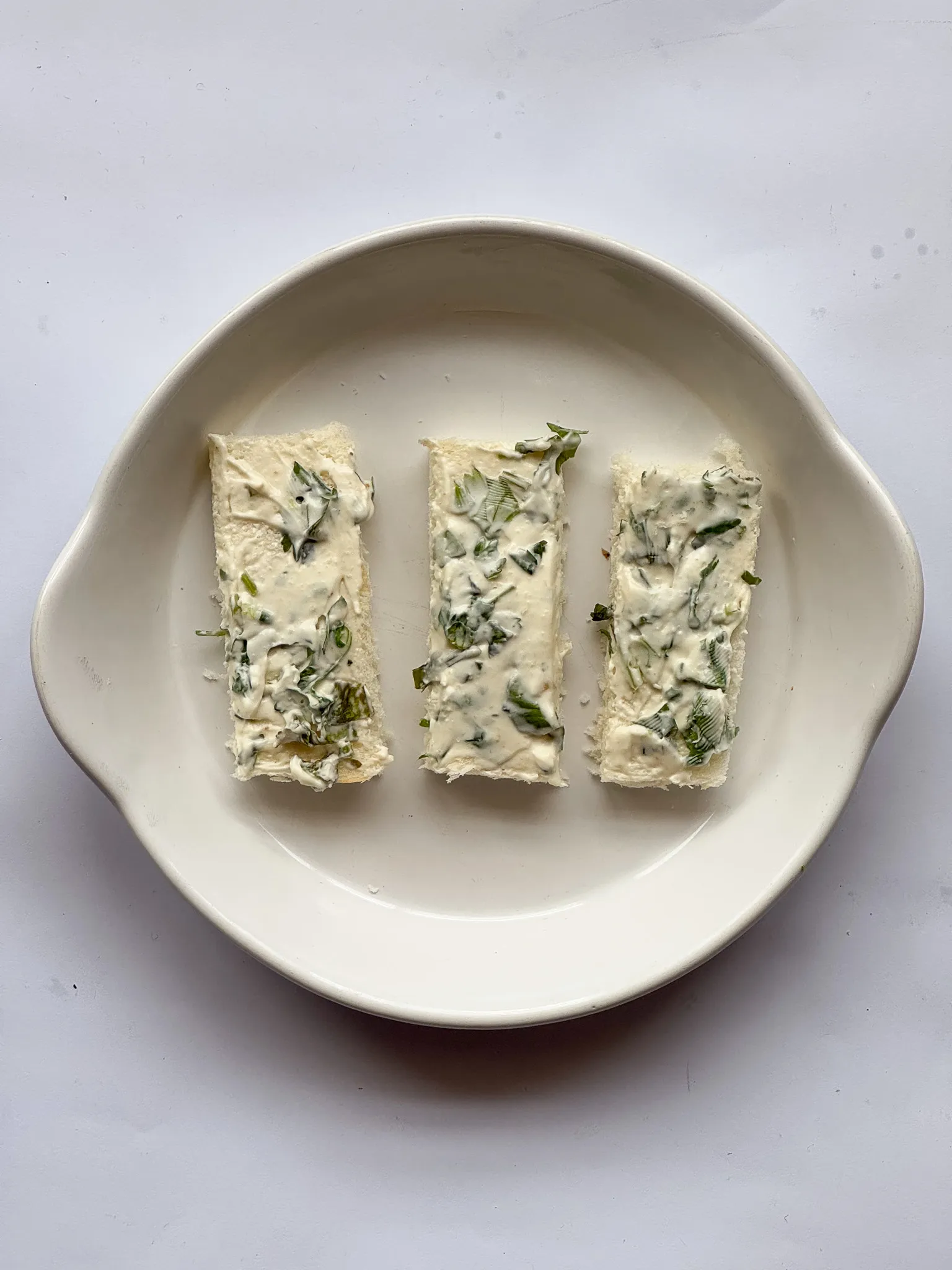 Cream cheese mix spread over the bread slices.