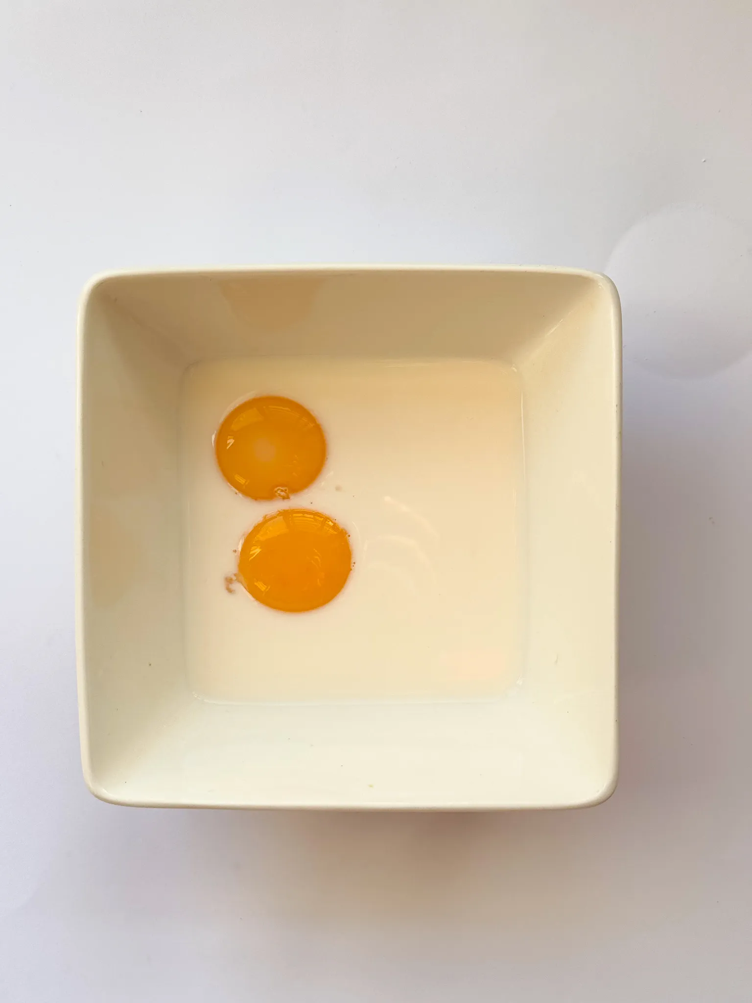 Milk and eggs in a bowl.