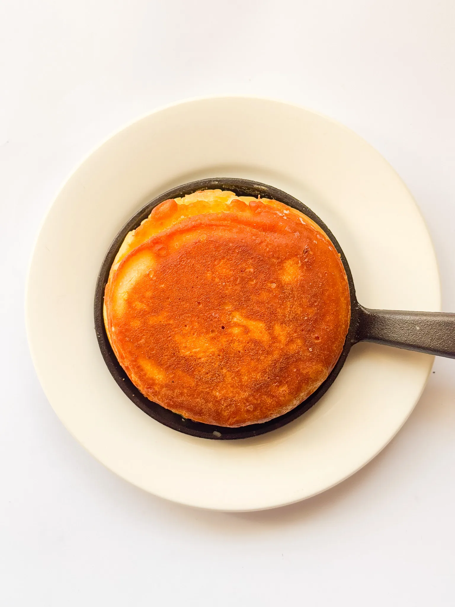Pancake batter cooking on a skillet.