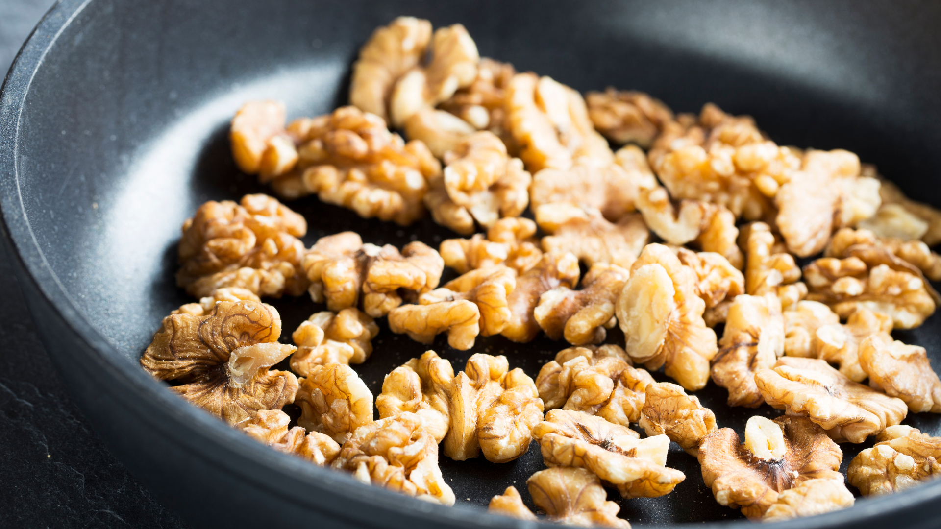 toast walnuts in skillet