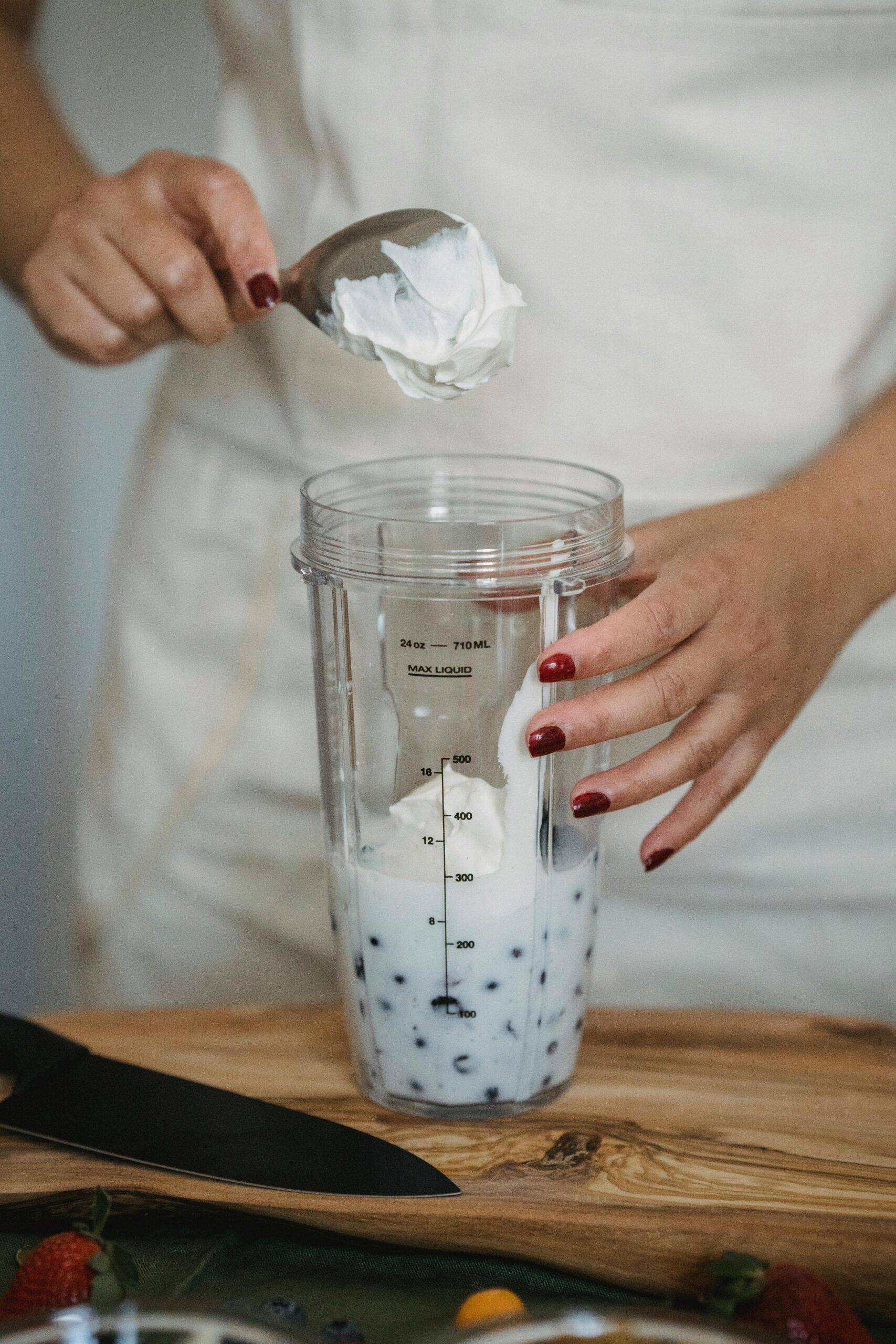 adding yogurt to blender