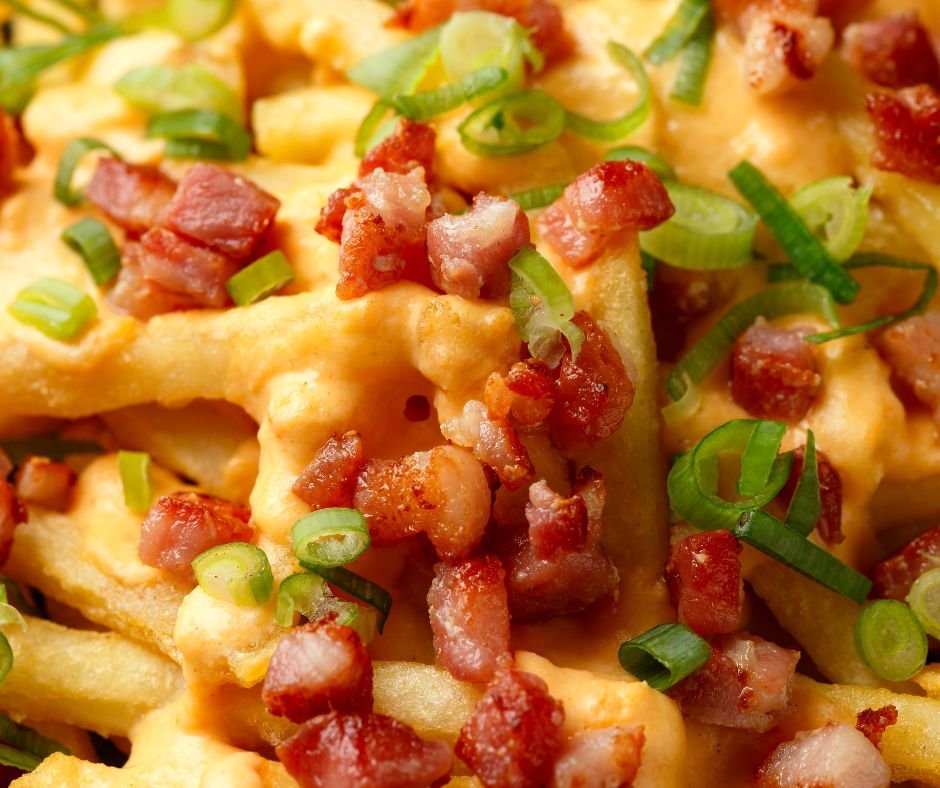 Crispy French fries loaded with bacon, cheese sauce and spring onion