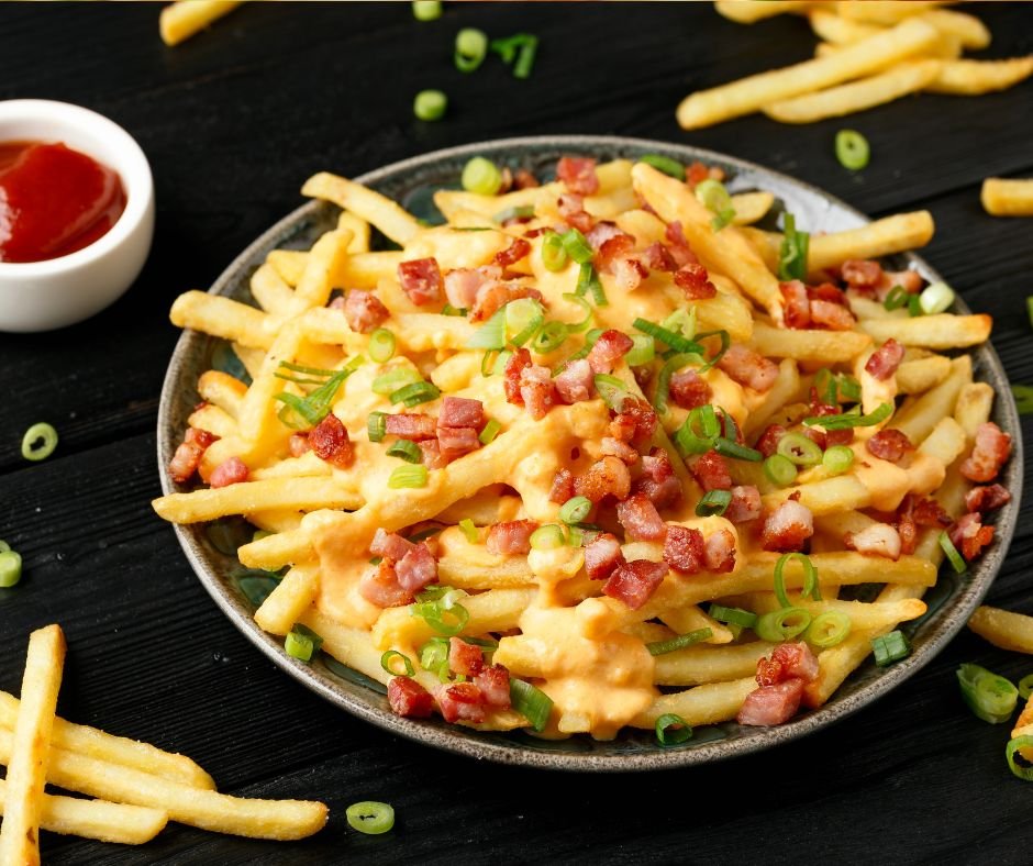 Crispy French fries loaded with bacon, cheese sauce and spring onion