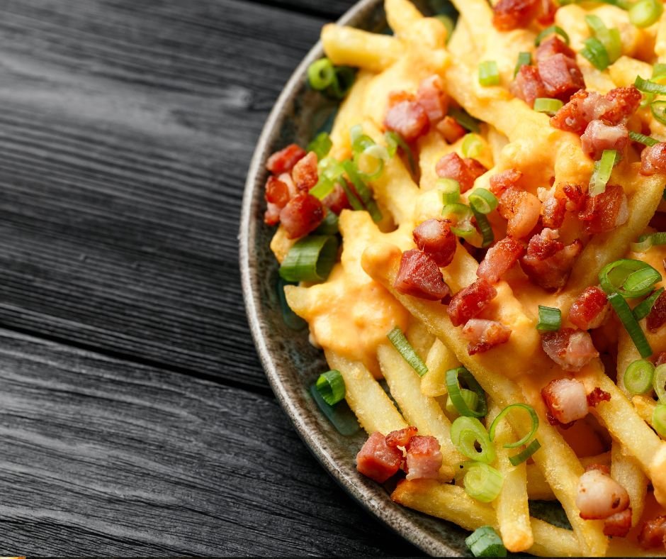 Crispy French fries loaded with bacon, cheese sauce and spring onion