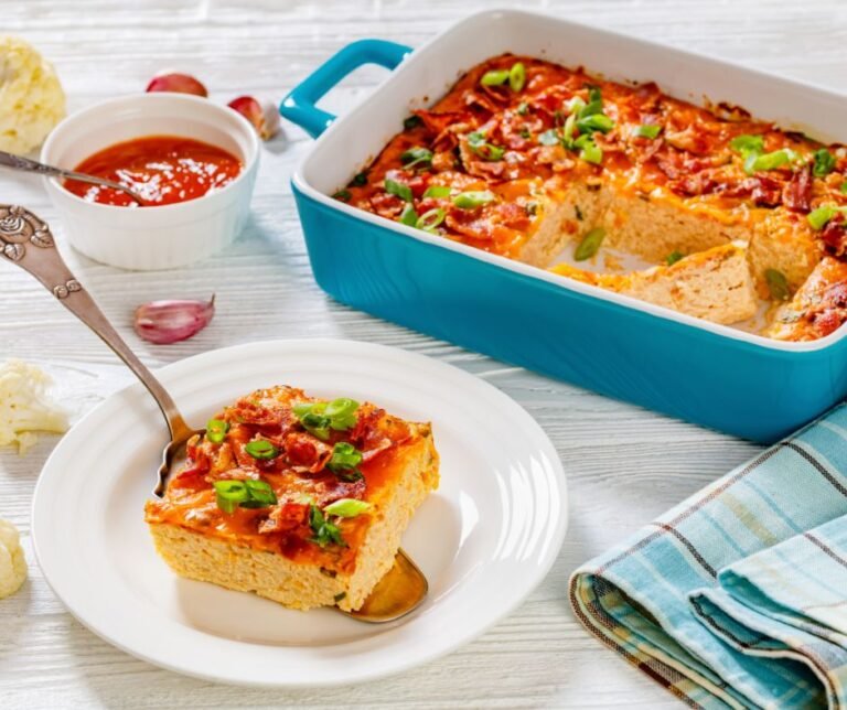 Riced Cauliflower Breakfast Casserole with Melted Cheese, Crispy Bacon and Green Onion