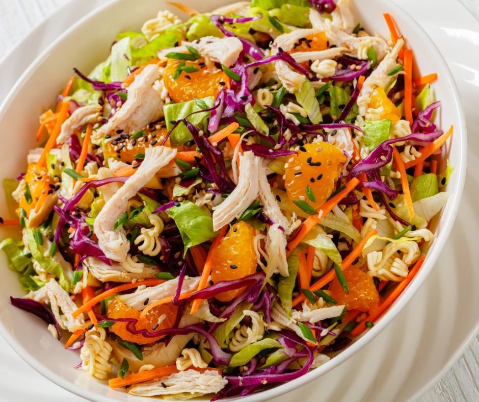 Chinese Chicken Salad with shredded chicken mandarin oranges crispy noodles red cabbage napa cabbage carrots and green onion